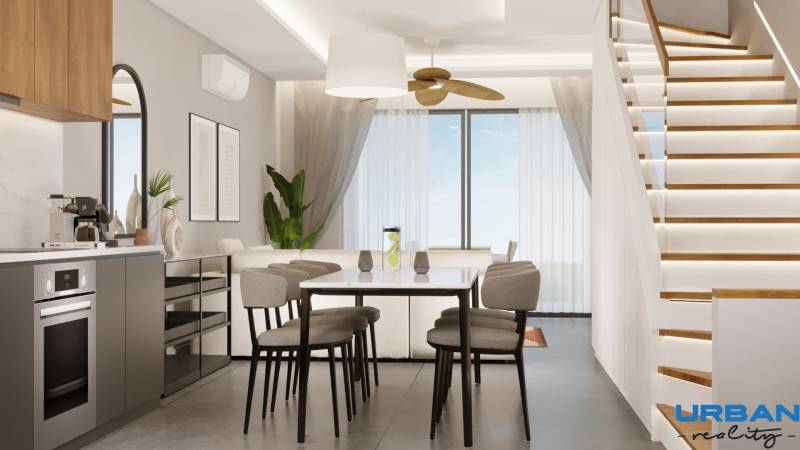 Jedáleň s moderným schodiskom a kuchynskou linkou vo výstavbe bytov.